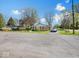 Charming single-story brick home featuring a well-manicured lawn, mature trees, and a paved driveway at 390 Lakeview Dr, Noblesville, IN 46060