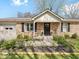 Close-up showcasing the brick facade, manicured landscaping, and inviting entrance of this charming single-story home at 390 Lakeview Dr, Noblesville, IN 46060
