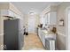 Galley kitchen with white cabinets, stainless steel appliances, and tile flooring offers a clean and efficient cooking space at 390 Lakeview Dr, Noblesville, IN 46060