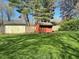 Large backyard featuring a green lawn, two storage sheds, and a wooden fence at 3920 Pigeon Creek Ln, Indianapolis, IN 46234