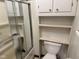 Cozy bathroom featuring a shower, toilet, and built-in shelving for added storage at 3920 Pigeon Creek Ln, Indianapolis, IN 46234