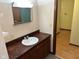 Functional bathroom featuring a vanity sink with wood cabinets and a mirror at 3920 Pigeon Creek Ln, Indianapolis, IN 46234