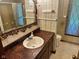 Ornate bathroom featuring vintage wallpaper, a vanity sink, and a shower-tub combination at 3920 Pigeon Creek Ln, Indianapolis, IN 46234