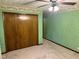 A bedroom features carpet, a closet, green textured walls, and a floral border at 3920 Pigeon Creek Ln, Indianapolis, IN 46234