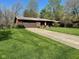 Beautiful single-story brick home on a large lot with a well-manicured lawn at 3920 Pigeon Creek Ln, Indianapolis, IN 46234