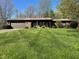 Charming brick home with a well-manicured lawn and a two-car garage on a beautiful day at 3920 Pigeon Creek Ln, Indianapolis, IN 46234