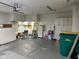 Spacious garage with white cabinets, room for storage, and concrete floor at 3920 Pigeon Creek Ln, Indianapolis, IN 46234