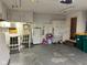 Functional garage features overhead storage, white cabinets, and concrete floor at 3920 Pigeon Creek Ln, Indianapolis, IN 46234