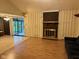 Open concept living room featuring a brick fireplace and sliding glass doors to the yard at 3920 Pigeon Creek Ln, Indianapolis, IN 46234