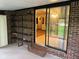 Back patio with outdoor shelving and sliding glass doors leading inside at 3920 Pigeon Creek Ln, Indianapolis, IN 46234