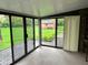 Sunroom featuring glass doors with a view of the greenery in the backyard at 3920 Pigeon Creek Ln, Indianapolis, IN 46234