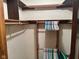 Organized walk-in closet featuring wooden shelves and hanging rods for ample storage solutions at 3920 Pigeon Creek Ln, Indianapolis, IN 46234