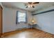 Bedroom features hardwood floors, floral wallpaper, and a window with light-filtering curtains at 4464 Chatham Dr, Brownsburg, IN 46112