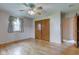Hardwood bedroom with closet and ceiling fan and a light-filled window at 4464 Chatham Dr, Brownsburg, IN 46112