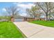 Wide shot of the home's exterior, featuring a brick facade and long driveway at 4464 Chatham Dr, Brownsburg, IN 46112