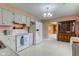 Traditional eat-in kitchen with white appliances and cabinets at 4464 Chatham Dr, Brownsburg, IN 46112