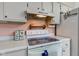 Close up of a white glass top stove and white countertops at 4464 Chatham Dr, Brownsburg, IN 46112