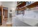 Laundry area with washer and dryer, utility sink, and open shelving at 4464 Chatham Dr, Brownsburg, IN 46112