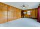 An ample room with wood paneling, ceiling fan, and carpet at 4464 Chatham Dr, Brownsburg, IN 46112
