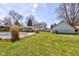 The expansive backyard includes a pool, well-maintained lawn, and privacy fence at 5014 Dawn St, Anderson, IN 46013