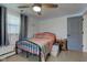 Cozy bedroom with a ceiling fan, side table, natural light, and modern decor at 5014 Dawn St, Anderson, IN 46013