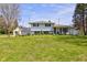 Charming two-story home featuring a lush front lawn and a detached garage with upper deck at 5014 Dawn St, Anderson, IN 46013