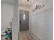 Stylish home entryway with decorative lighting, plank walls, and a colorful accent rug at 5014 Dawn St, Anderson, IN 46013