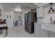 Bright eat-in kitchen featuring subway tile backsplash, stainless steel refrigerator and grey cabinetry at 5014 Dawn St, Anderson, IN 46013