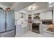 Modern kitchen featuring white cabinetry, stainless steel appliances, and bright lighting at 5014 Dawn St, Anderson, IN 46013