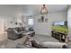 This cozy living room features a comfortable sofa, decorative touches and a large television at 5014 Dawn St, Anderson, IN 46013