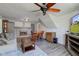 Gathering room featuring decorative fireplace, ceiling fan, a tv and an open floorplan at 5014 Dawn St, Anderson, IN 46013