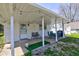 Covered patio area features string lights, two chairs and an outdoor dining set at 5014 Dawn St, Anderson, IN 46013