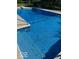 An in-ground pool features blue patterned tiling and a concrete surrounding at 5014 Dawn St, Anderson, IN 46013