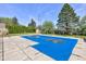 View of a pool covered with a worn blue tarp that has collected water in places at 5014 Dawn St, Anderson, IN 46013