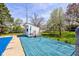 Pool house with blue deck is surrounded by a well-maintained, fenced-in yard at 5014 Dawn St, Anderson, IN 46013