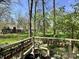 Backyard view of a well-manicured lawn, tall trees, and lush gardens with lots of curb appeal at 5205 Mosswood Ct, Indianapolis, IN 46254