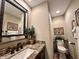 Updated powder room featuring granite counters, modern fixtures, and a decorative mirror at 5205 Mosswood Ct, Indianapolis, IN 46254