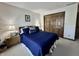 Comfortable bedroom featuring a queen bed with a blue comforter and matching nightstands at 5205 Mosswood Ct, Indianapolis, IN 46254