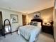 Cozy bedroom with a queen-sized bed, neutral walls, and two bedside tables at 5205 Mosswood Ct, Indianapolis, IN 46254