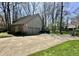 Spacious home exterior featuring a large driveway, basketball hoop, and attached two-car garage at 5205 Mosswood Ct, Indianapolis, IN 46254