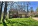 Charming brick home with a manicured lawn, mature trees, and a bright red front door at 5205 Mosswood Ct, Indianapolis, IN 46254