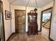 Hallway with decorative cabinet and tiled floor, connecting to other rooms in the house at 5205 Mosswood Ct, Indianapolis, IN 46254