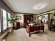 Elegant home office with custom wood cabinets, large desk, and natural light from the large window at 5205 Mosswood Ct, Indianapolis, IN 46254