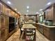 Well-equipped kitchen with stainless steel appliances, custom cabinets, and granite island seating at 5205 Mosswood Ct, Indianapolis, IN 46254