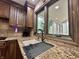 Close-up of the kitchen sink and countertop, featuring tiled backsplash and wood cabinets at 5205 Mosswood Ct, Indianapolis, IN 46254