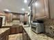 Kitchen featuring granite countertops, tile backsplash, and wood cabinets at 5205 Mosswood Ct, Indianapolis, IN 46254