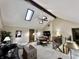 Bright living room with vaulted ceilings, skylights, exposed beams, and a staircase at 5205 Mosswood Ct, Indianapolis, IN 46254