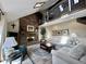 Inviting living room featuring a brick fireplace, high ceilings, and a cozy seating area at 5205 Mosswood Ct, Indianapolis, IN 46254