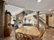 Open-concept living area with a brick fireplace, staircase, and dining area at 5205 Mosswood Ct, Indianapolis, IN 46254