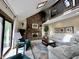 Cozy living room with a brick fireplace, vaulted ceilings, and a second story landing at 5205 Mosswood Ct, Indianapolis, IN 46254
